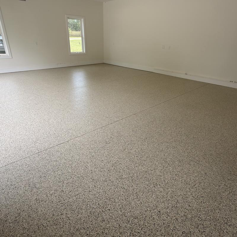 Large room with a tan full-flake epoxy floor