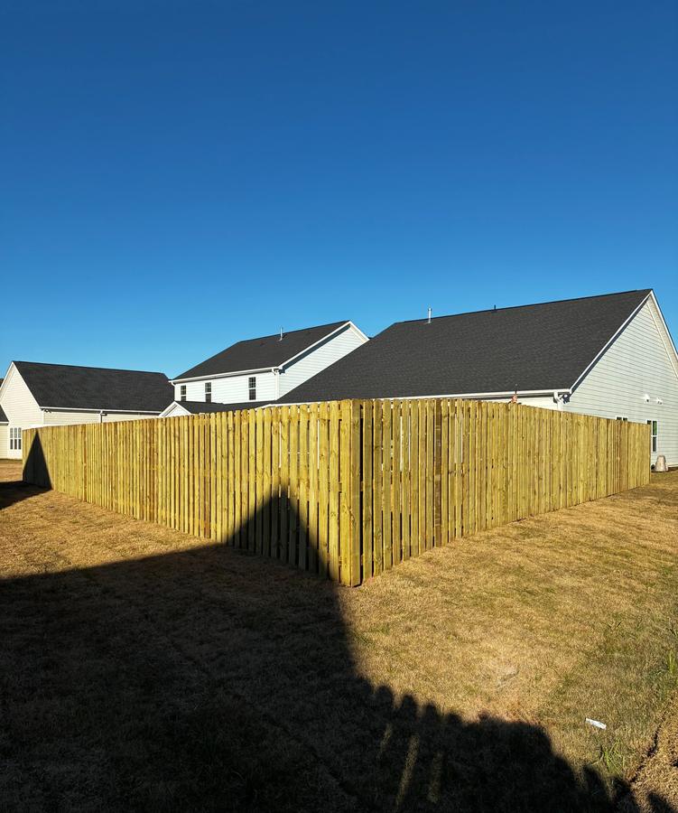 Wood privacy fence wrapping the corner of a backyard